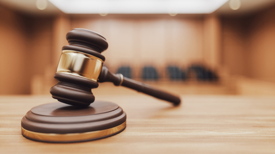Gavel on a Courtroom Desk stock photo