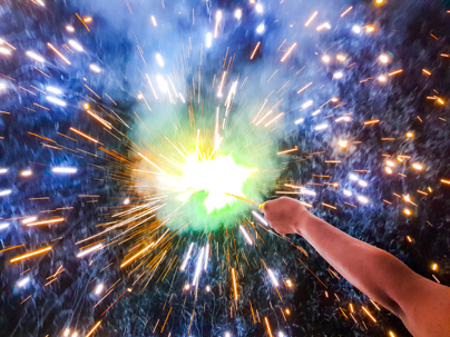 Hand charki, a hand firework emitting circular sparks in black background stock photo