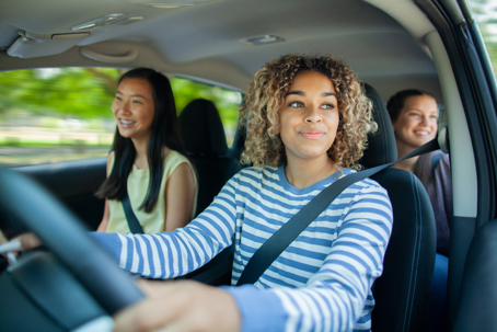 three teen females driving in a car